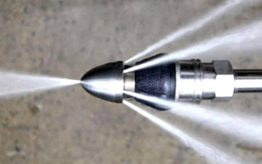 Hydro jetting nozzle clearing a clogged residential sewer pipe in Miami